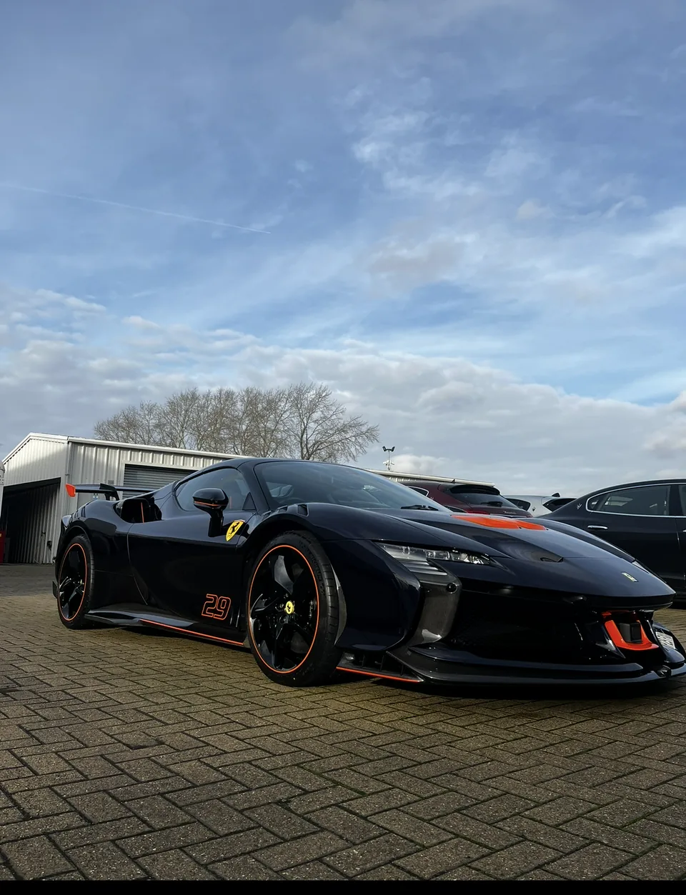Black Ferrari sports car photographed outside