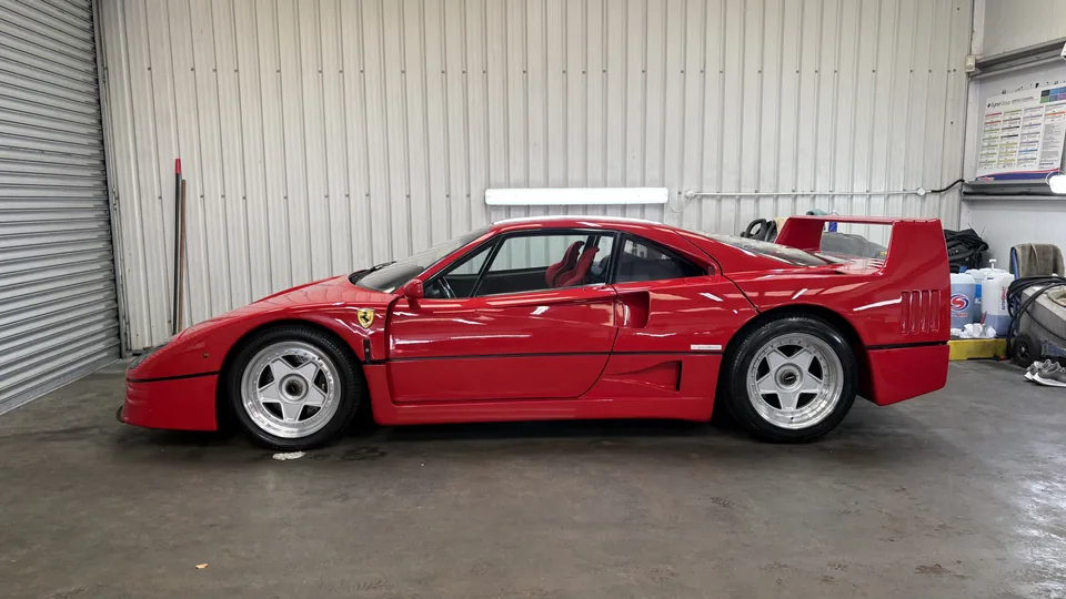 Red Ferrari F40 shown side-on inside the detailing workshop