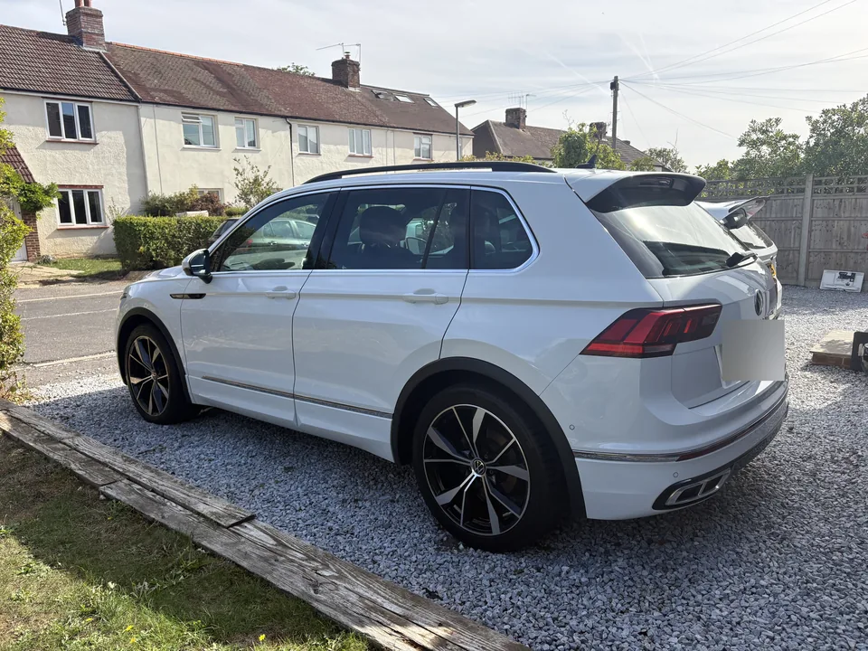White Volkswagen Tiguan parked on gravel